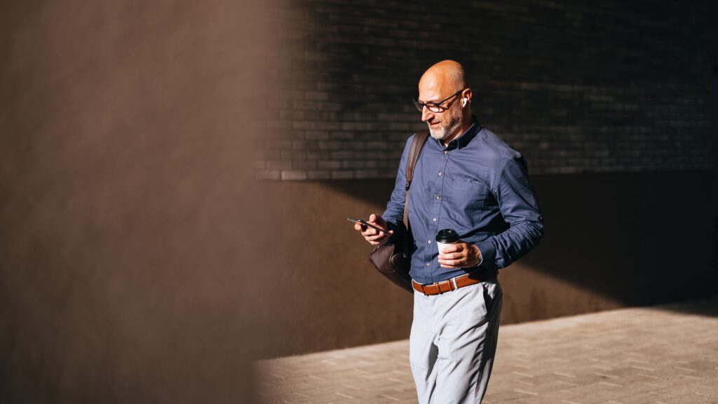 Man on phone symbolizing researching of Restricted Stock Units or RSUs