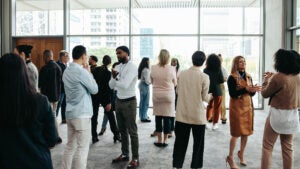 A group of people at a lobby conference symbolizing the Nasdaq Private Market Experiences Record Growth in 2018
