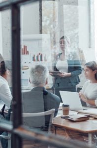 Business professionals discussing charts and data in a corporate meeting room