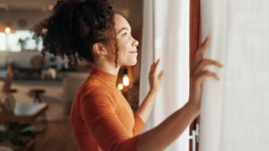 Woman looking out the window symbolizing learning about Secondary Markets What You Need to Know About the Market for Private Company Stock